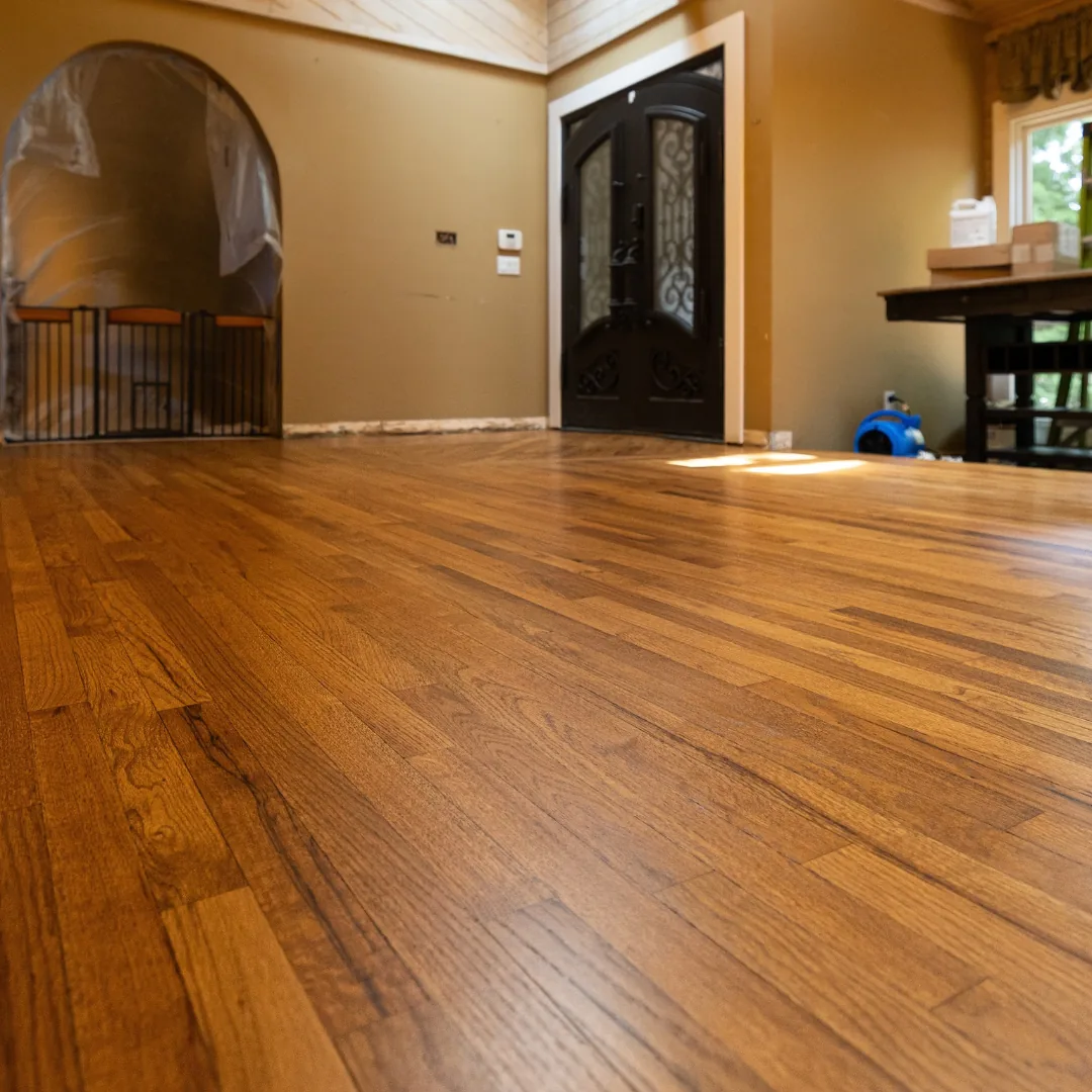 Newly installed hardwood floors in a spacious room.