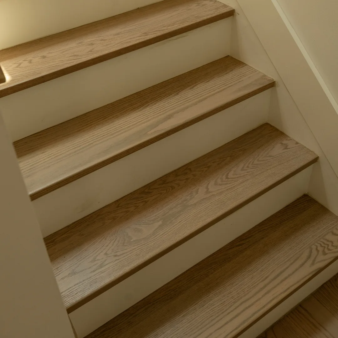 Refinished light brown wooden staircase steps