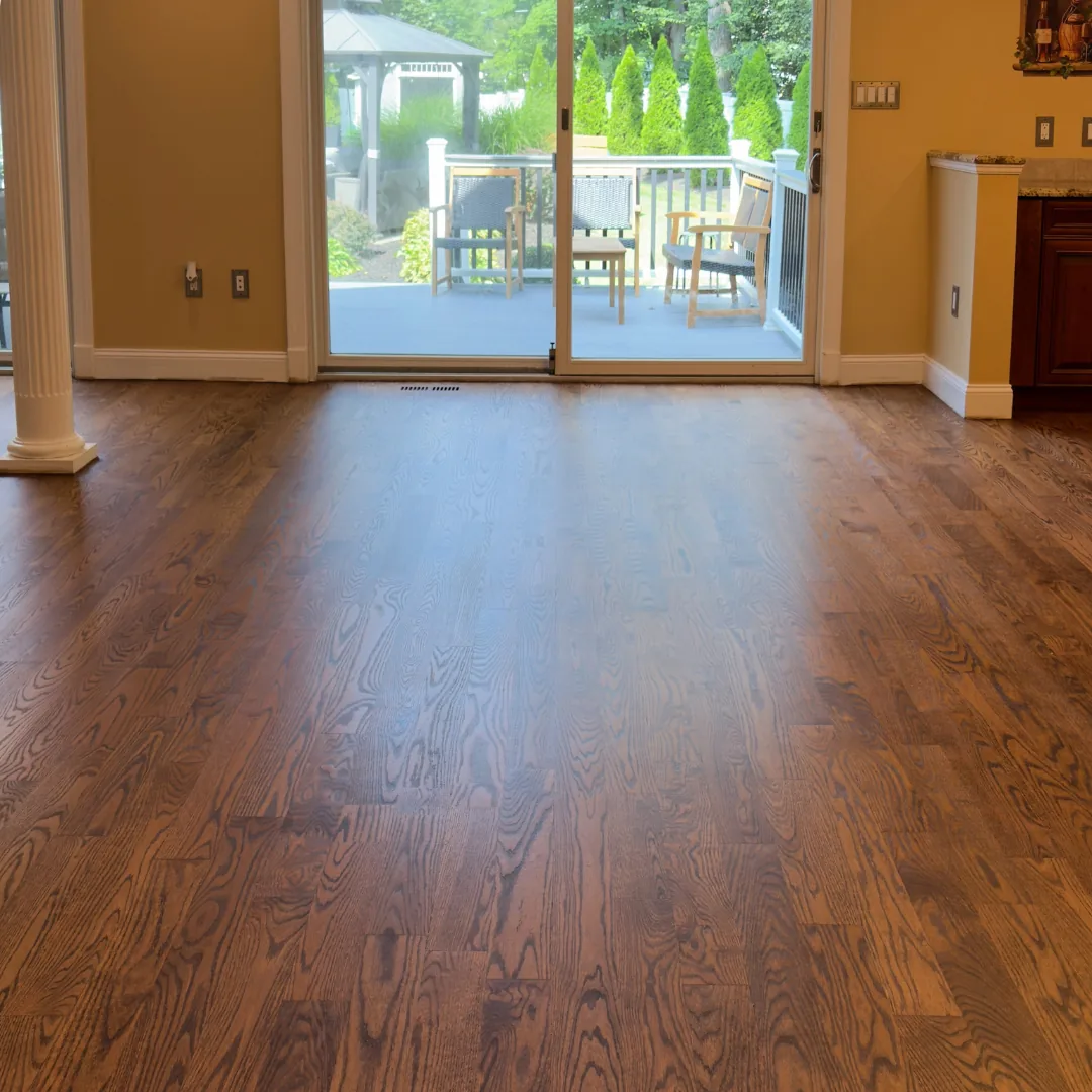 Newly installed dark hardwood floors with sunlight