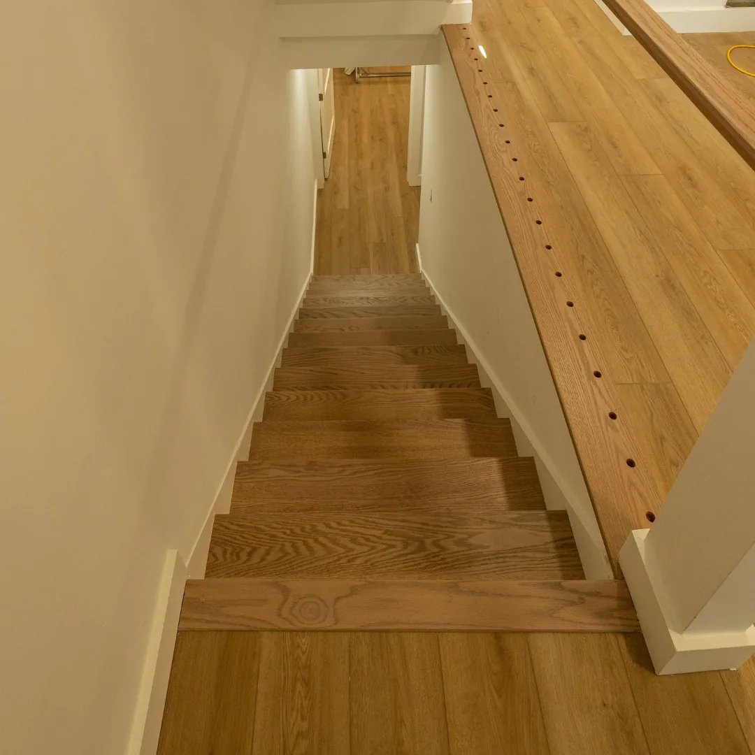 Newly installed hardwood staircase and landing in progress.